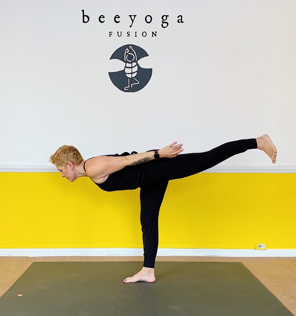 Gretchen Schock at Bee Yoga Fusion in a warrior three position
