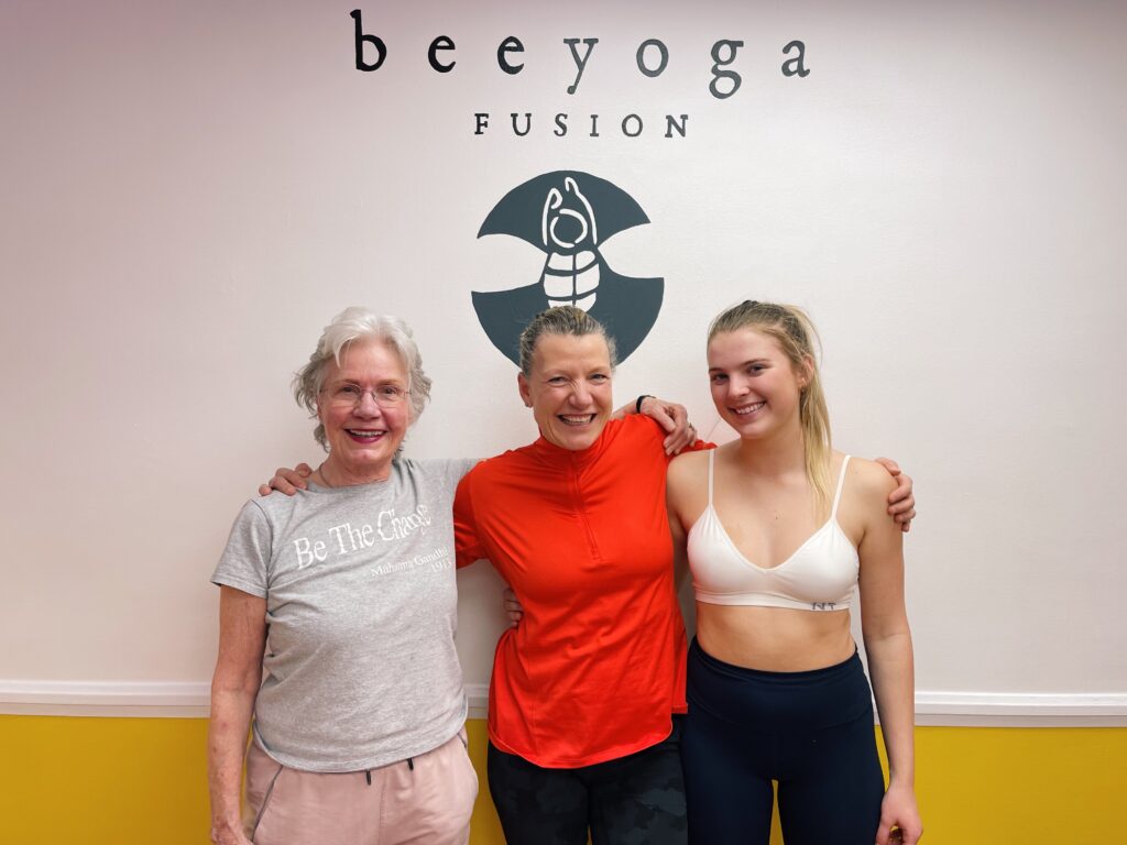 Three generations of a family practicing yoga together at bee yoga fusion