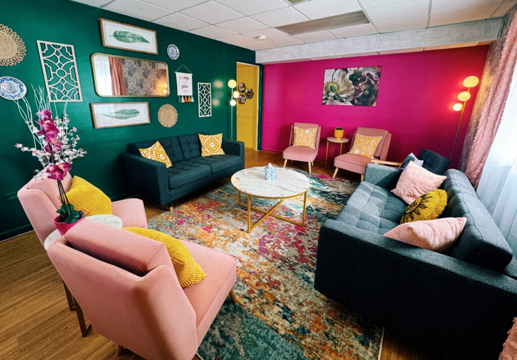 bee yoga fusion coaching room that is very welcoming and beautifully decorated with plush chairs and sofas.