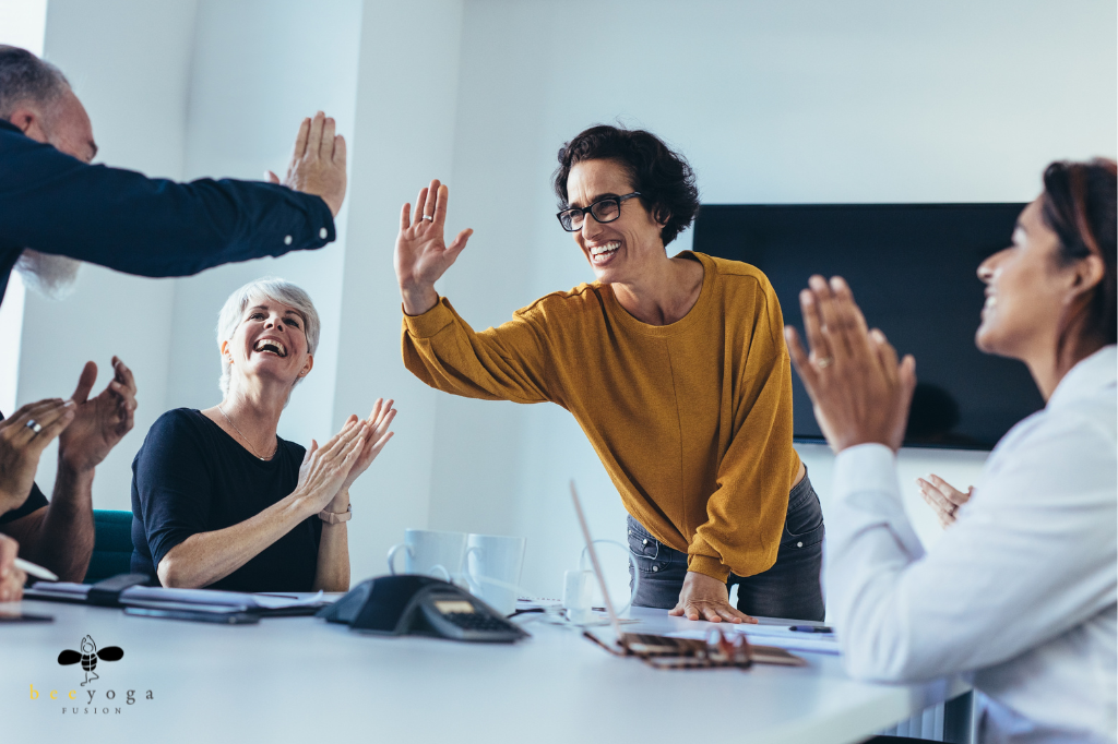 middle aged woman high five a coworker