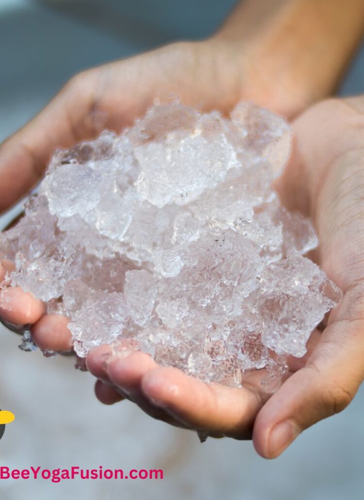 two hands holding small ice cubes