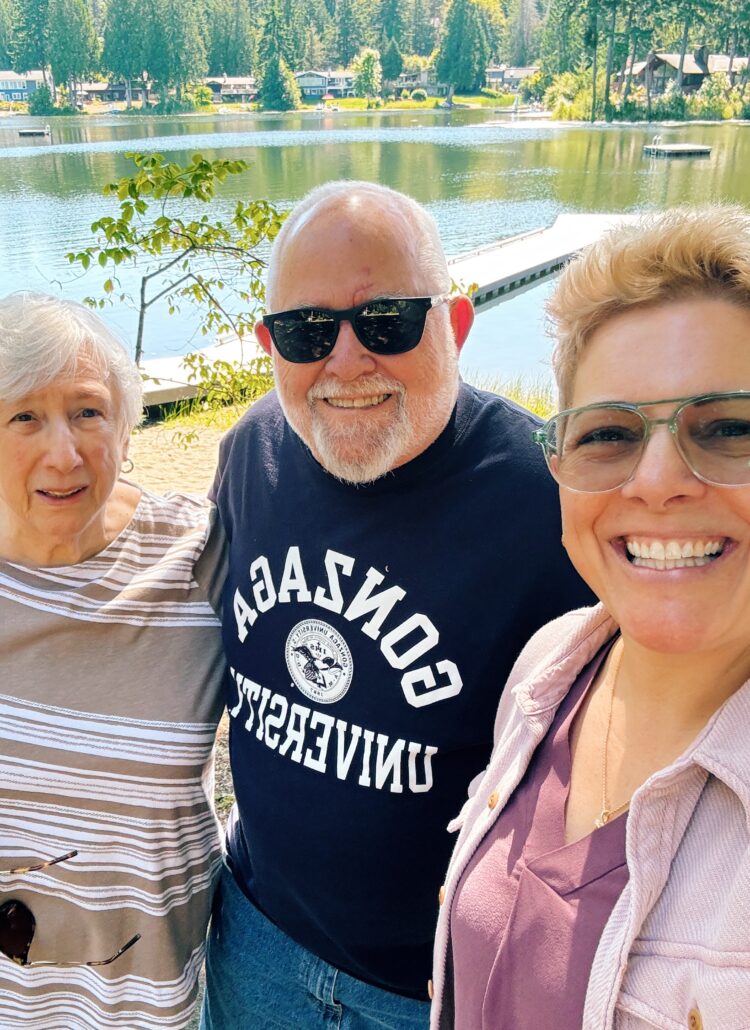 gretchen with her aunt and uncle and a lake in the background