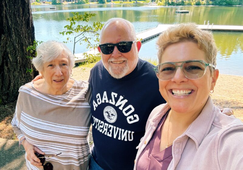 gretchen with her aunt and uncle and a lake in the background