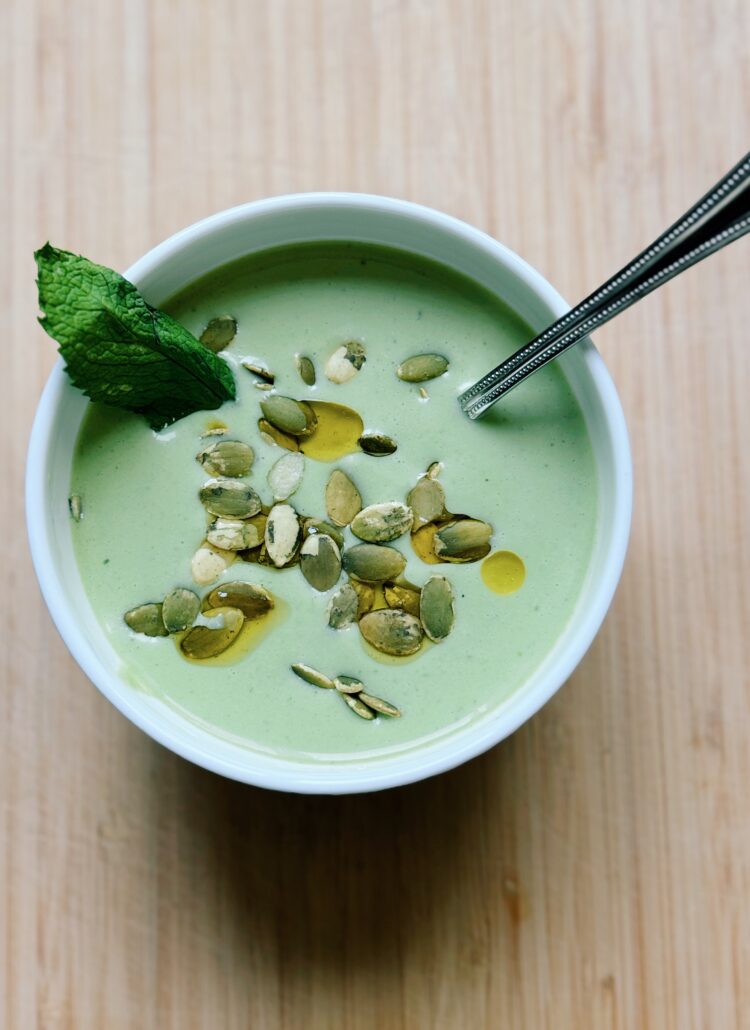 cucumber and basil soup with a spoon in the bowl