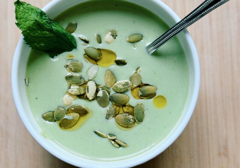 cucumber and basil soup with a spoon in the bowl