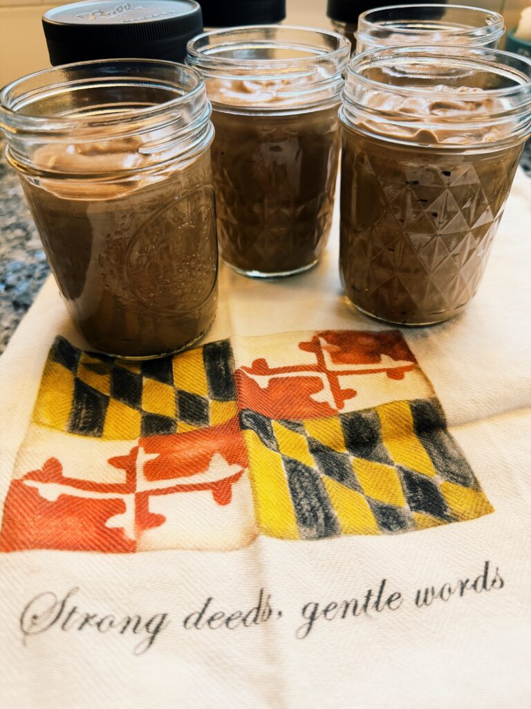 picture of the dessert in canning jars on a kitchen towel with the Maryland flag that says : strong deeds, gentle words