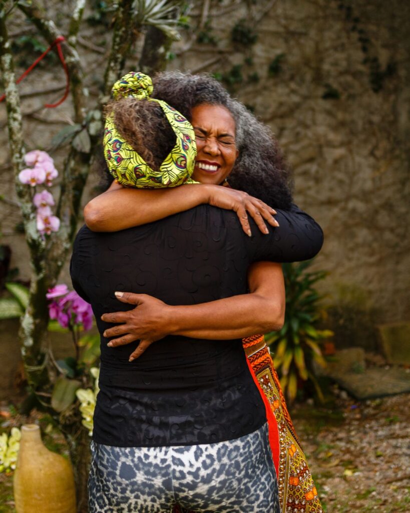 two middle aged black women hugging